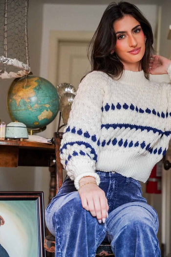 Beautiful girl in cableknit swearer sitting at a desk