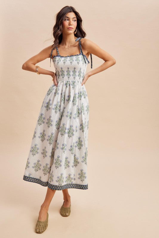 Woman wearing a floral dress on a beige background