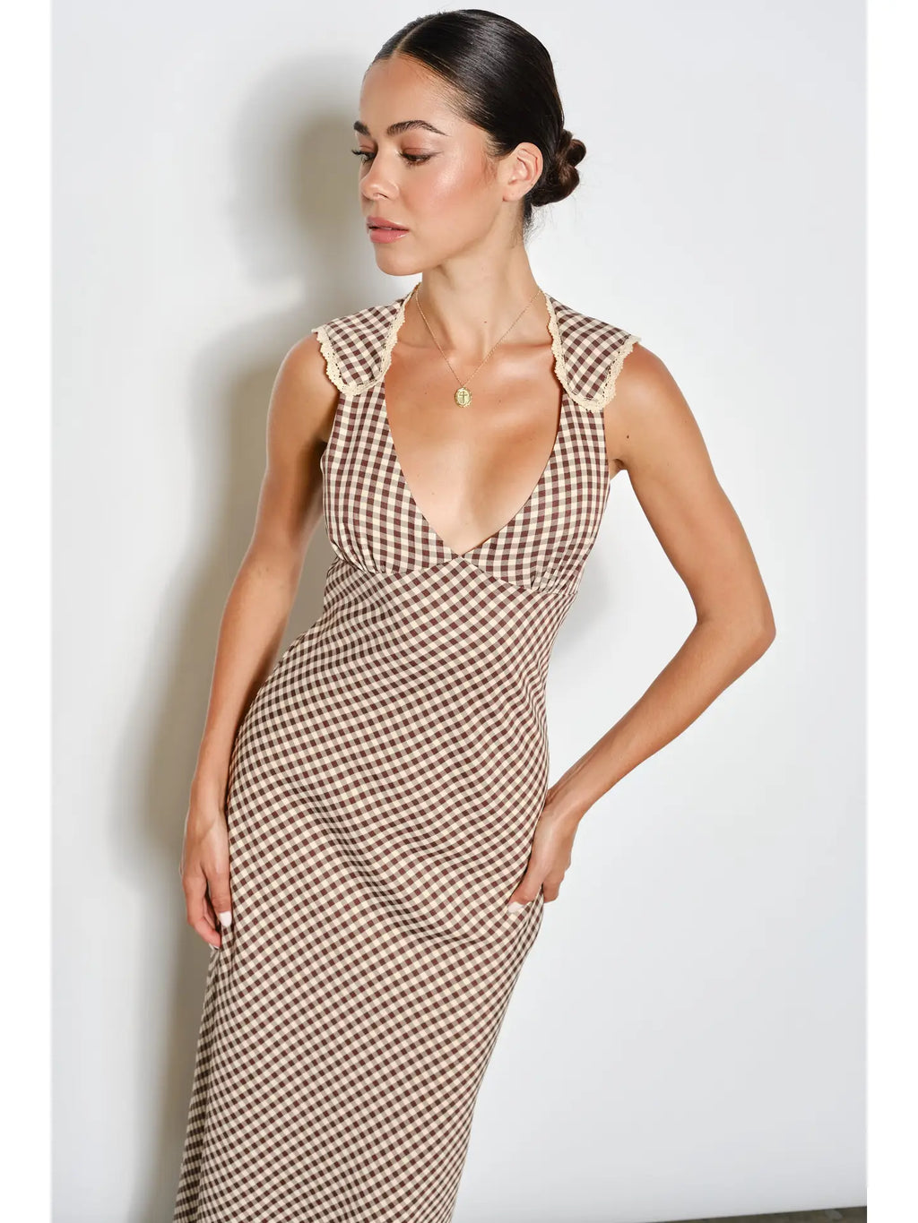 Woman wearing a patterned dress against a white background