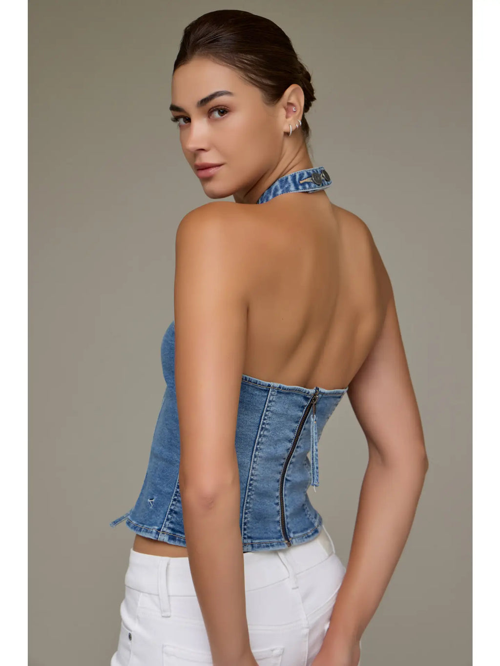 Women with denim halter and white pants 