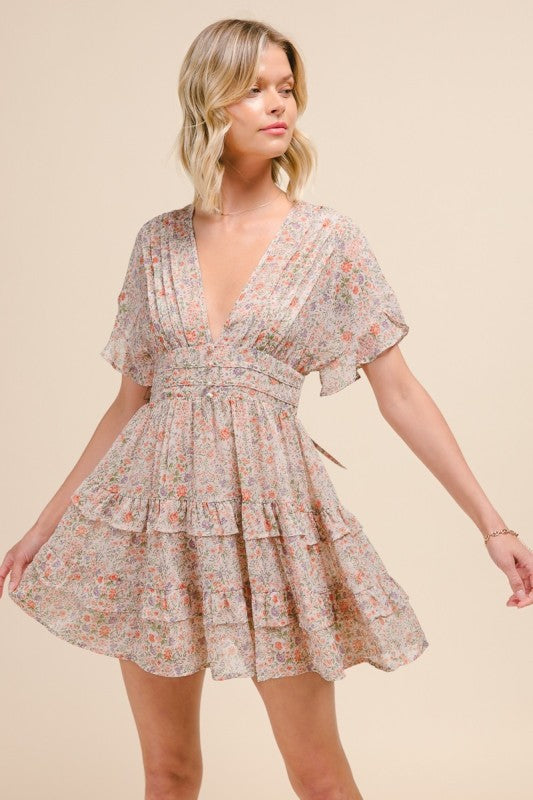 Woman wearing a floral dress against a beige background