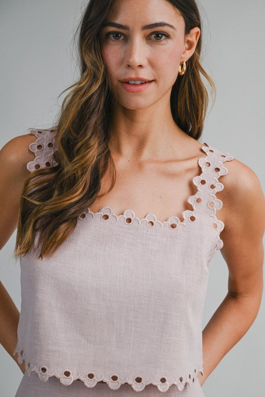 Women Wearing two piece top with skirt with a grey background 