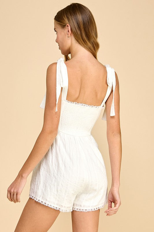 Woman wearing a white dress against a beige background
