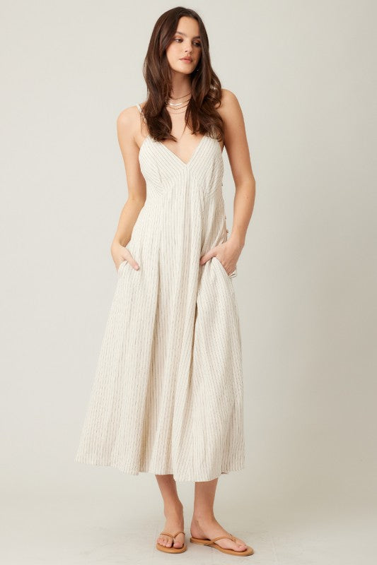 Beige Pinstripe dress with button details on a neutral background