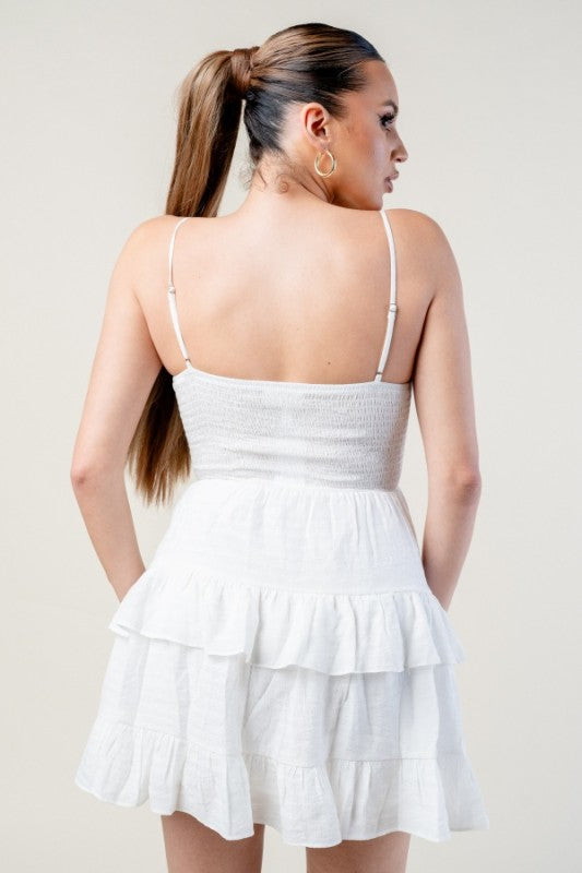 Woman wearing a white dress on a plain background