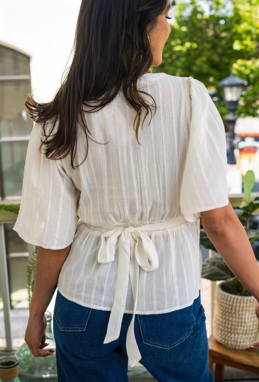 Women wearing White blouse with blue jeans and a blur background 