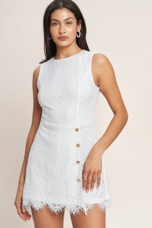 Woman wearing a white lace dress on a plain background