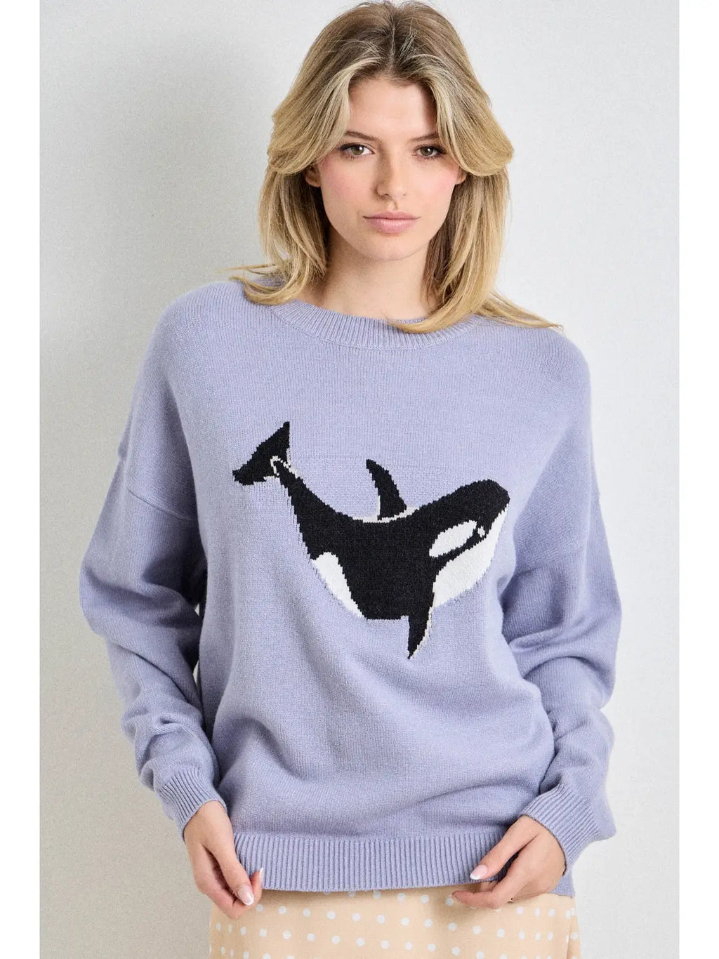Light purple sweater with a black orca whale design on a plain background