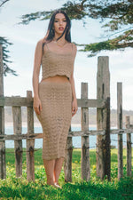 woman wearing crochet skirt and crop top set on beach 