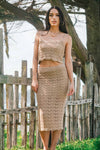 woman wearing crochet skirt and crop top set on beach 