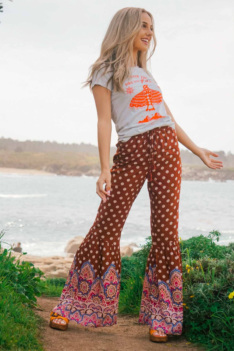 girl wearing boho pants and graphic tee in Carmel California