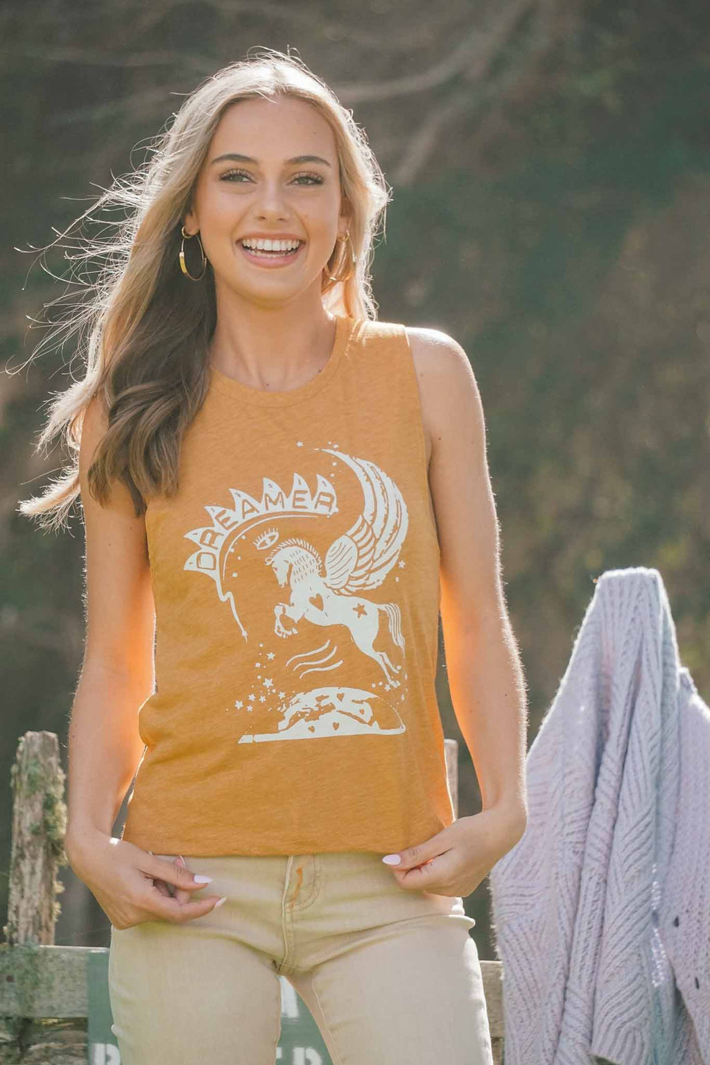 woman laughing in dreamer graphic tee