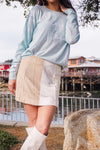 woman in skirt and sweater near Fishermans wharf in Monterey California 